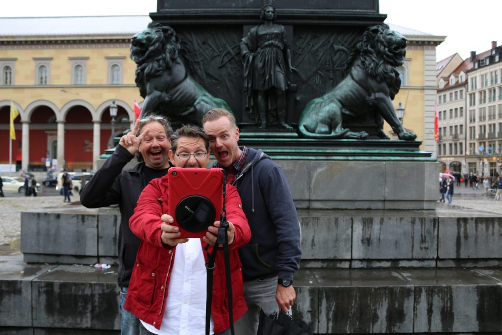 Personen stehen im freien vor einem iPad